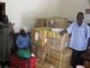 TSMP staff proudly stand beside a new shipment (bi-monthly) of medical supplies, including boxes of anti-malarials, bought in Kampala.
