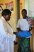An expectant mother at the TSMP clinic receiving a bed net.