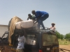 The nets are loaded in to the truck by the men and women aid workers