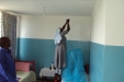 Huruma - School staff members helped hang students’ nets.