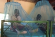 KONGWA-SEC The girls happily try out their new nets. With plenty of space they can sleep or study mosquito free!