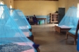 Hombolo: The young pupils look on as their dormitory is transformed into a far safer sleeping environment.