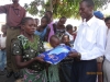 A baby receiving a long-lasting insecticidal net.
