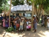 Children gather around at the start of another distribution.